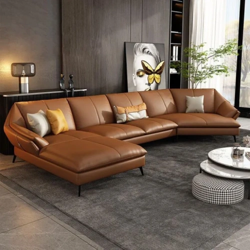 A modern, brown leather sectional sofa with a chaise lounge