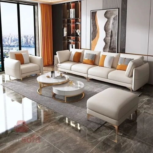 A modern living room featuring a large, white leather sectional sofa with a chaise lounge.